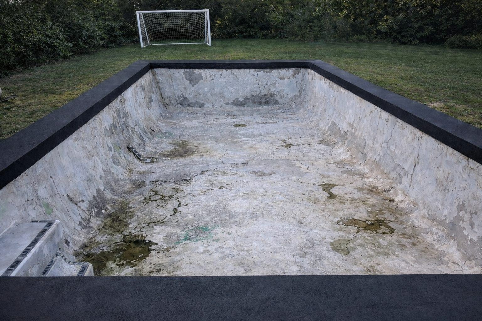 Pool before resurfacing โ concrete pool, worn marblesheen